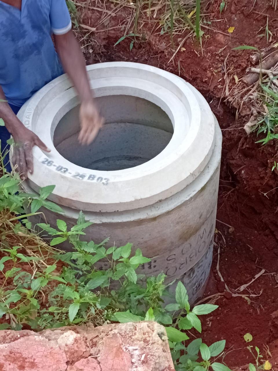 Precast concrete manhole rings being installed underground